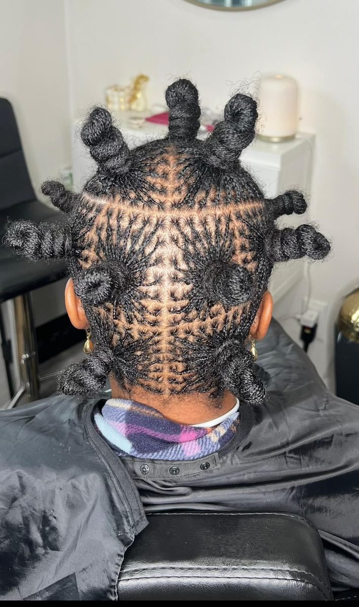 Client with long box braids styled at Locs by Hair Arena